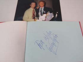 Autograph book signed by George Best, Dennis Law and Jimmy Greeves plus one other and a photo signed