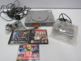 Playstation one with 2 controllers and 2 games.