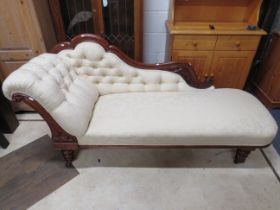 Early 20th Century Chaise with carved spring arm support and clean and tidy upholstery.. Raised on t
