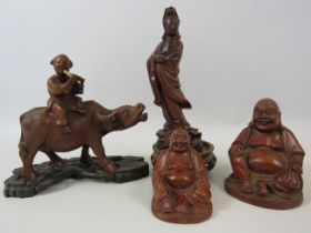 Selection of oriental carved wood figures.