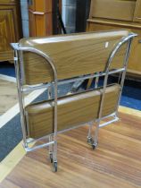 Well designed folding serving trolley. Made from tubular chromed steet and folding laminate trays. R