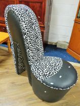 Bedroom chair shaped as a ladies shoe. Finished in leatherette and animal print fabric. Measures H: