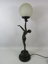 Art deco style figural table lamp with globe shade, approx 26" tall.