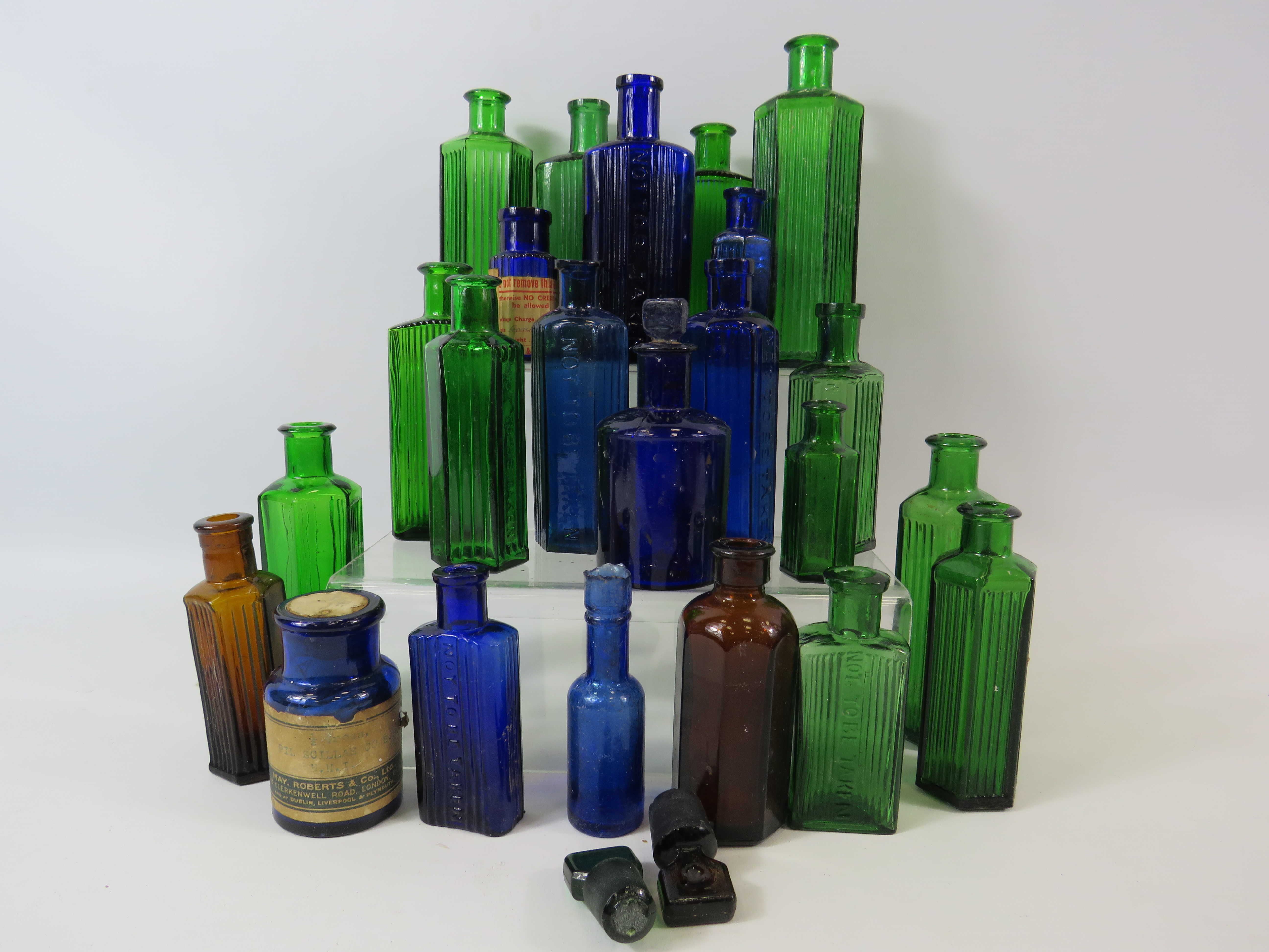 23 Vintage coloured medicine bottles, blue, green and brown.