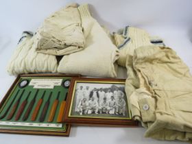 Vintage cricket clothing and a vintage cricket bat history wall plaque.