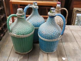 Four Wine bottles with raffia cloaking. Each with screw top. See photos. S2
