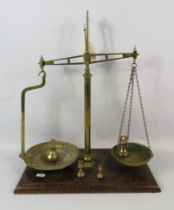 Set of W & T Avery brass balance scales on a wooden base. Approx 19" tall.