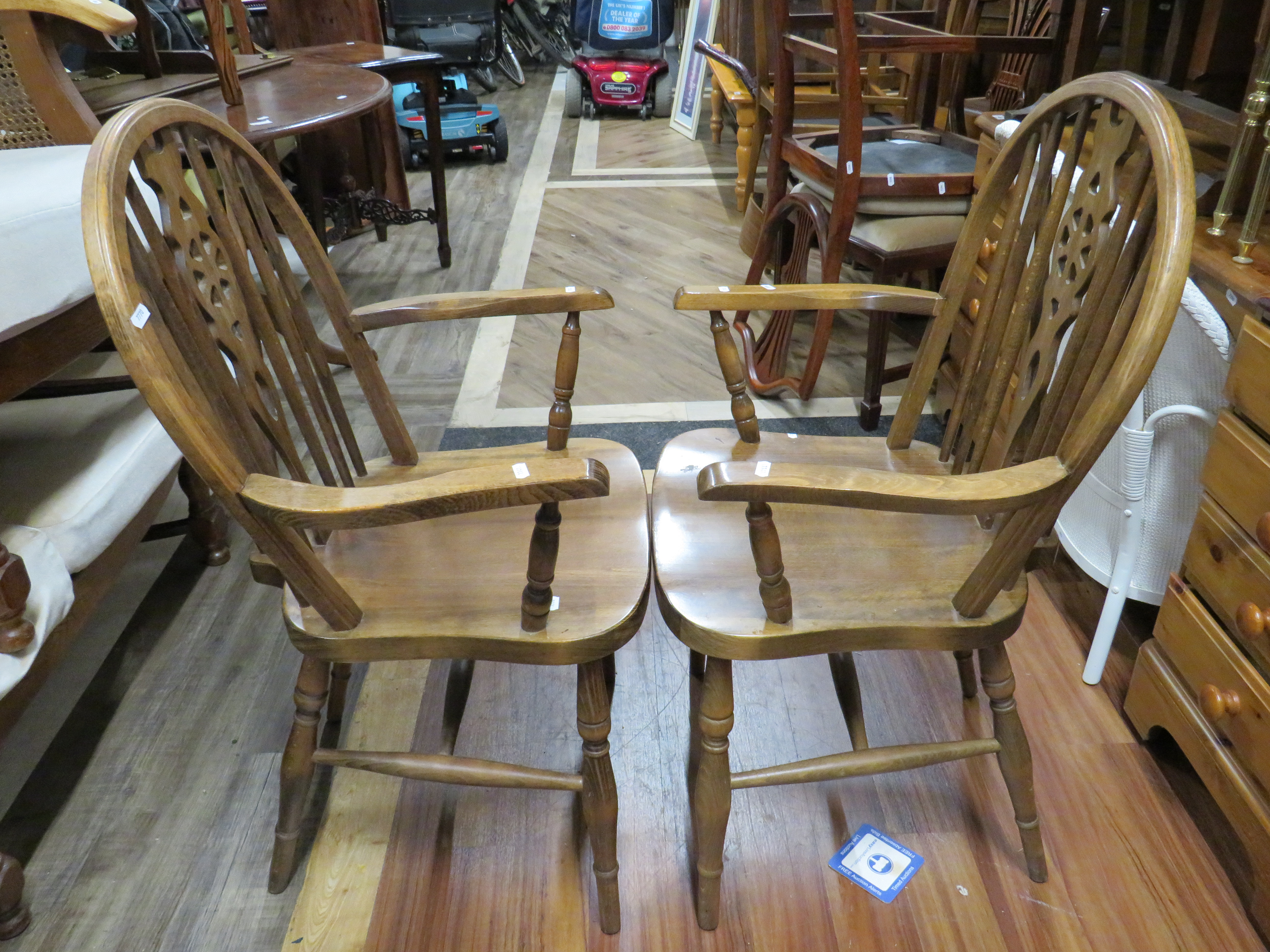 Pair of nicely made wheelbacked chairs with turned supports.   See photos.  S2