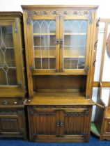 Old Charm style Dresser with Linem fold carved decoration to doors. Exposed hinges. Glazed bookshelf