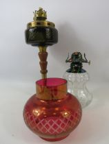 2 vintage oil lamps and a cranberry glass shade.