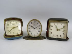 2 Vintage travel clocks and a small mantle clock by Smiths and Swiza.