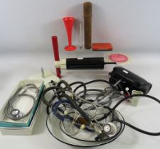 Large selection of stethoscopes and vintage medical instruments.