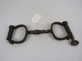 Pair of cast iron antique handcuffs.