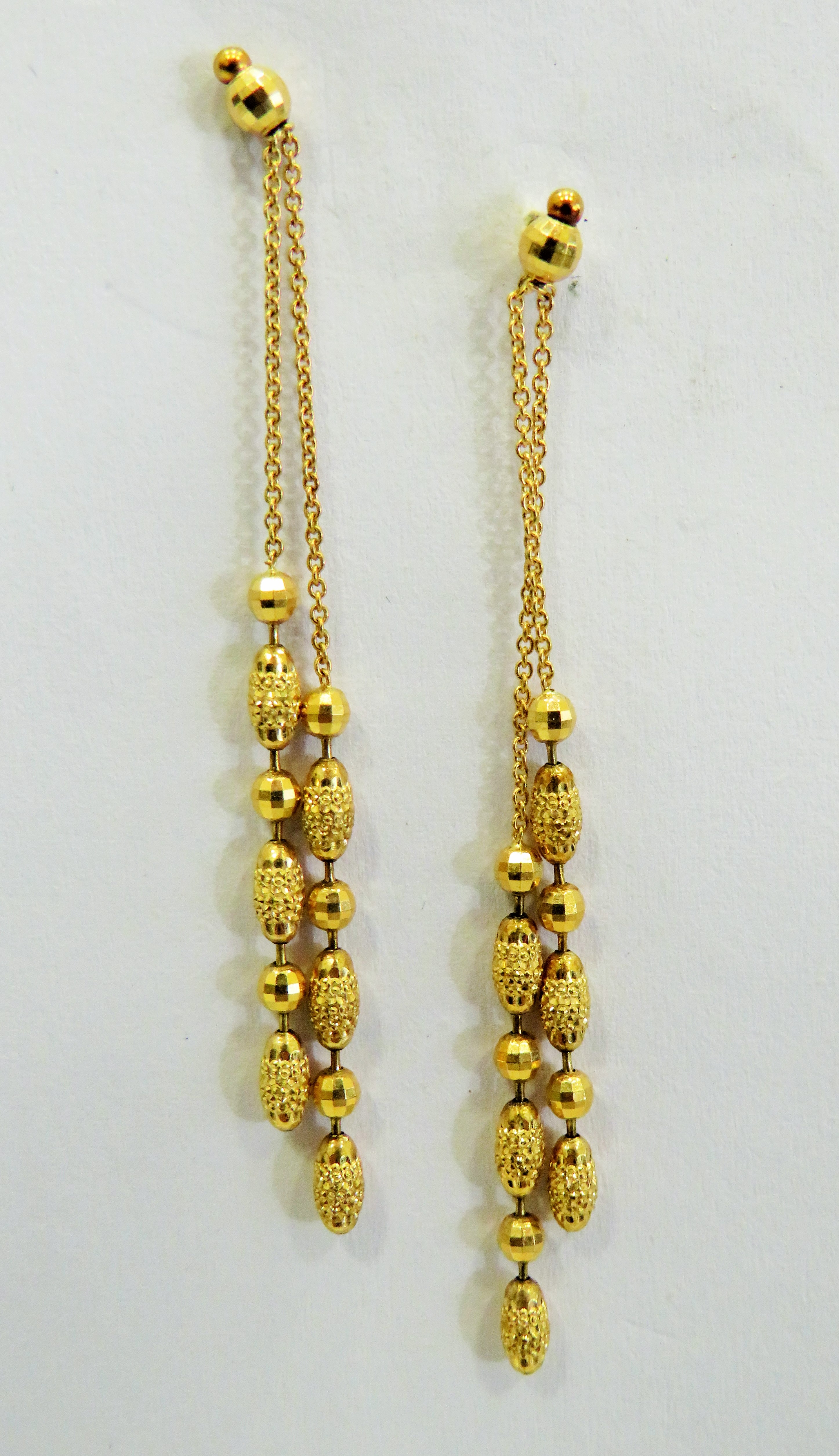 Pair of 9ct Twin strand drop earrings interspersed with globes and tapered cylinders. Good quality s