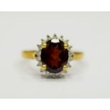 9ct Yellow Gold Ring set with a Large Central Garnet which measures approx 20 x 12mm and is surround
