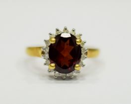 9ct Yellow Gold Ring set with a Large Central Garnet which measures approx 20 x 12mm and is surround