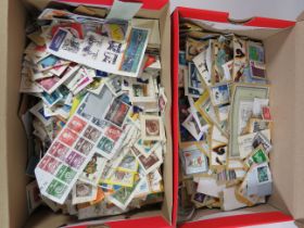 Two shoeboxes filled with assorted loose world stamps. See photos.