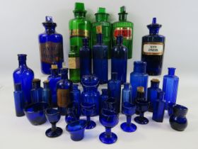 Good selection of vintage medical bottles and eye wash baths in emerald green and bristol blue.