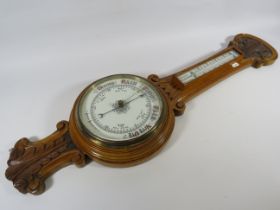 Oak case barometer / thermometer with enamel face.