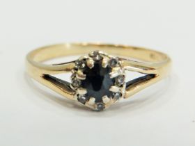 9ct Yellow Gold ring set with a central Sapphire with large claw mounts and surrounded by small Mele