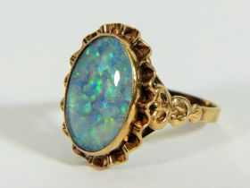 Yellow metal ring (testing 9ct) set with large reconstitued Opal which measures 20 x 14 mm Finger s
