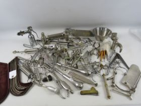 Large selection of various vintage metal medical instruments.