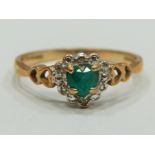 9ct Yellow Gold ring set with a Central Heart shaped Emerald with Melee Diamond surround.   Finger s