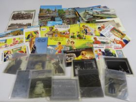 Mixed lot of vintage glass negatives and postcards including Bamforths comical.