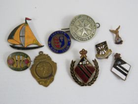 Selection of various vintage enamel badges.