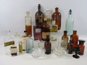 Large selection of various coloured vintage medical bottles.