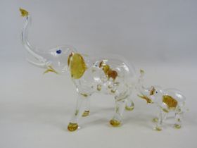 Two hand blown glass Elephants with smaller elephants within, the tallest measures 6" tall.