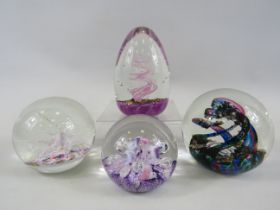 4 Selkirk glass paperweights.