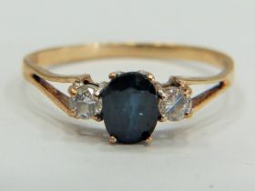 9ct Gold ring set with a Central Sapphire supported by small CZ gemstones to each side. Finger size