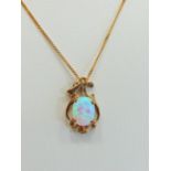 9ct Gold Art Nouveau style pendant set with a high coloured Opal hung on an 18 inch 9ct Chain.  Tota