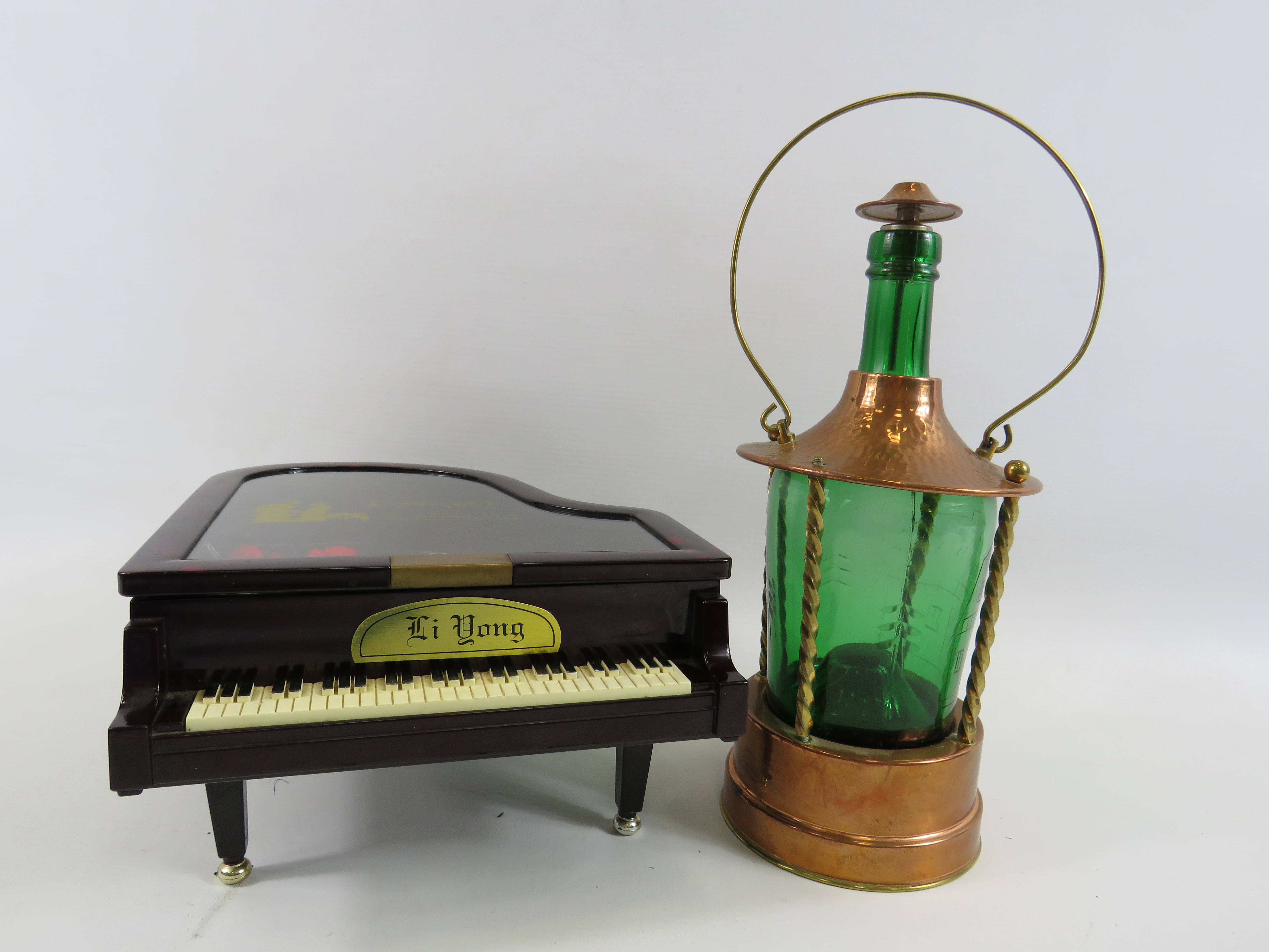 Musical decanter in the form of a lantern and a musical jewellery box in the form of a piano.