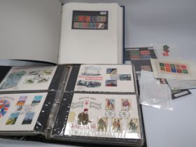 Part filled album of mint stamps and a folder full of First day covers.