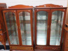 Matched pair of mirror backed glass display cabinets with glass doors. Both illuminated with 240v lI