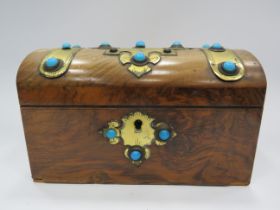 Vintage tea caddy in the style of a treasure chest decored with brass and turquoise stones.