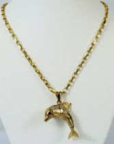 9ct Yellow Gold Articulated pendant as a leaping Dolphin set with multiple clear gemstones, hung on