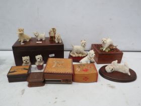 Selection of vintage wooden trinket boxes and West Highland terrier figurines.