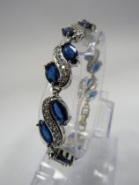 925 Silver bracelet set with blue and clear gemstones and has a extention piece.