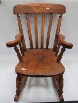 Antique Childs Rocking chair made from Oak. Serpentine shaped arms and splayed back. Chair in lovely