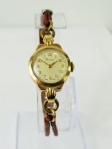 Swiss Made ladies watch by 'Pioneer' in running order. 9ct Gold case. Worn leather strap. Estimated