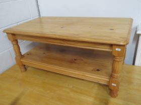 Solid knotty pine table with handy shelf under. Measures approx H:18 x W:39 x D:22 Inches. See photo