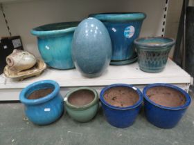 Various garden plant pots / planters in green, turquoise and blue.