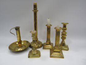 Selection of brass candlesticks the tallest measures 14 inches.