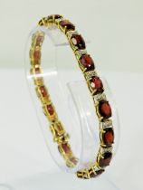 14ct Yellow Gold Garnet and Diamond set bracelet. 7 inches long. 13g