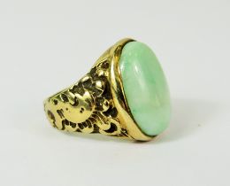 Large Oval Jade ring set in a heavy 9ct Mount with scrolled shoulders. Finger size 'Q' Total wei