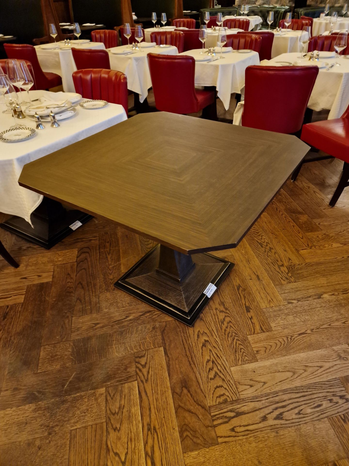 A bespoke Robert Angell Churchill dining table the oak top mounted above a shaped square pedestal