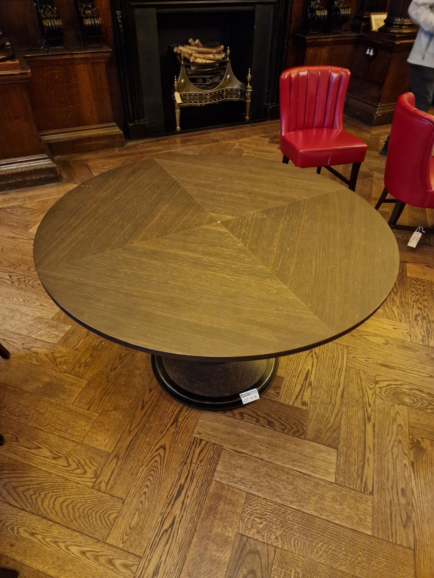 A bespoke Robert Angell Churchill circular dining table the oak top mounted above a shaped square